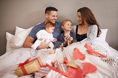 Buy stock photo Gift box, love and happy family in a bed with celebration of birthday, event or mothers day at home together. Support, care or kids with parents in bedroom with thank you, present or bonding in house