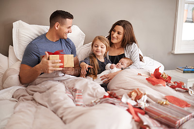 Buy stock photo Bedroom, gift or family with celebration, Christmas or bonding together with happiness, morning or festive season. Parents, mother or father with children, excited or kids with presents, home or Xmas