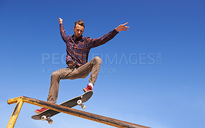 Buy stock photo Fitness, energy and man with skateboard, jump or rail balance at a skate park for stunt training. Freedom, adrenaline and gen z male skater with air, sports or skill practice, exercise or performance