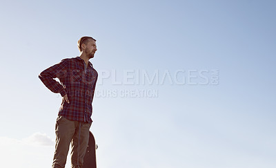 Buy stock photo Skateboard, thinking and man at a skate park with idea for trick, stunt or adrenaline sports on blue sky background. Planning, calm and male skateboarder with reflection, questions or memory on ramp