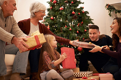 Buy stock photo Family, present and christmas in home with love, giving and care together at holiday event. Happy, smile and tree with celebration, child and marriage in a house with grandparents and festive gift