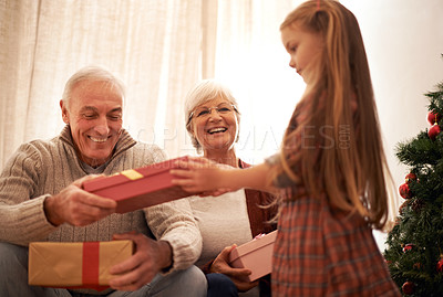 Buy stock photo Family, christmas giving and gifts with kids and grandparents together with tree in living room. Home, happy and present with holiday and celebration at a party with love, care and bonding with smile
