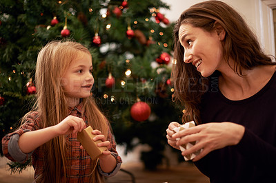 Buy stock photo Christmas gifts, family and mother with girl, having fun or bonding in home. Love, care and happy mom with child opening presents on xmas day, smile or enjoying quality holiday time together in house
