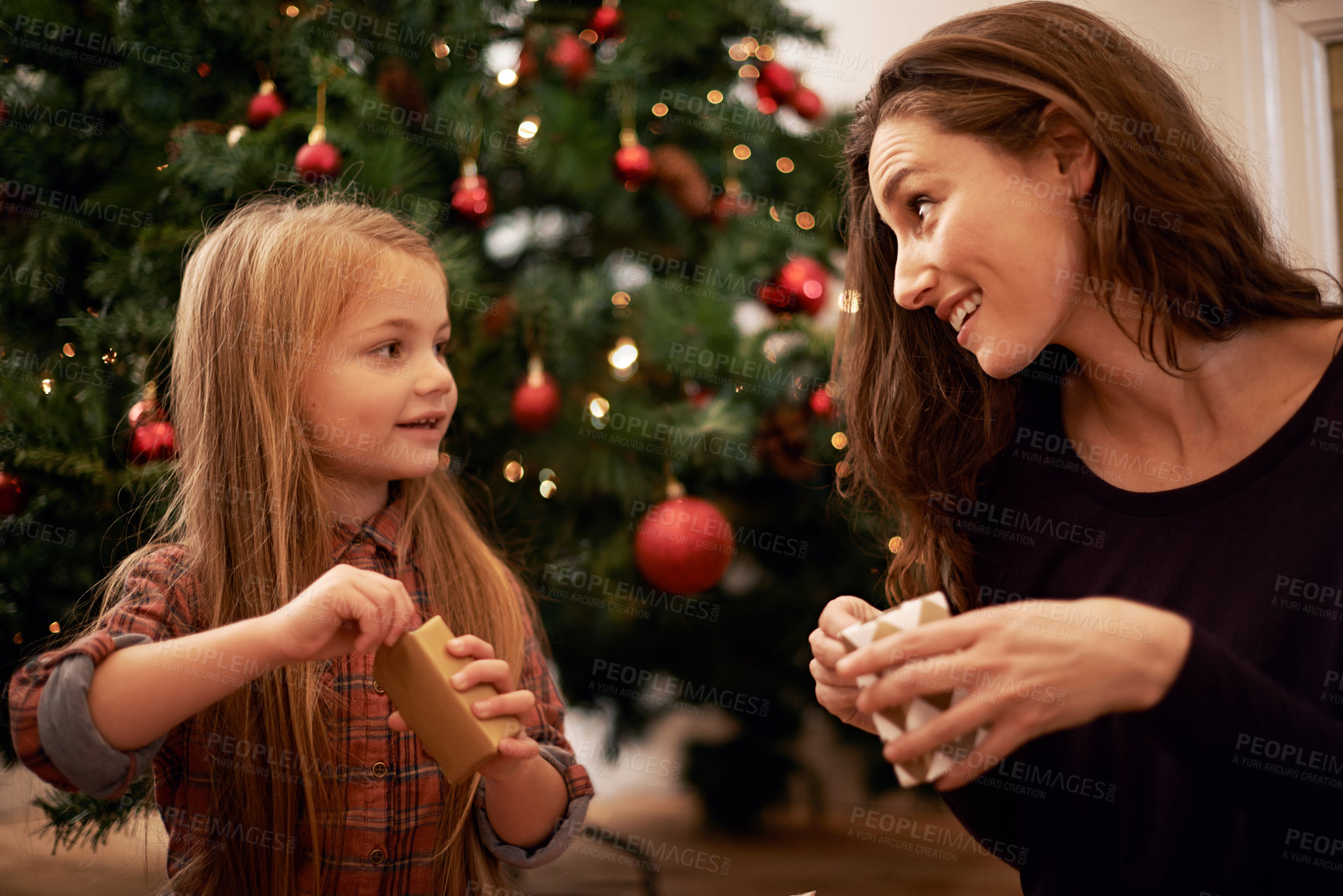 Buy stock photo Christmas gifts, family and mother with girl, having fun or bonding in home. Love, care and happy mom with child opening presents on xmas day, smile or enjoying quality holiday time together in house