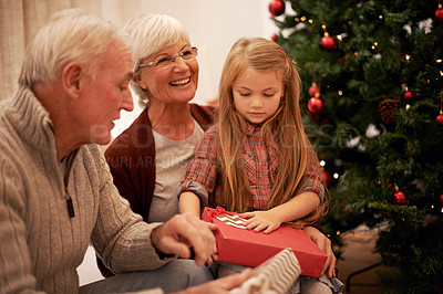 Buy stock photo Shot of a little girl spending Christmas with her grandparents