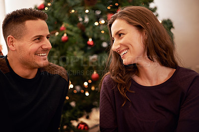 Buy stock photo Couple, love and christmas at home with bonding, support and care together at holiday event. Happy, smile and tree with celebration, trust and marriage in a house with relationship and festive decor