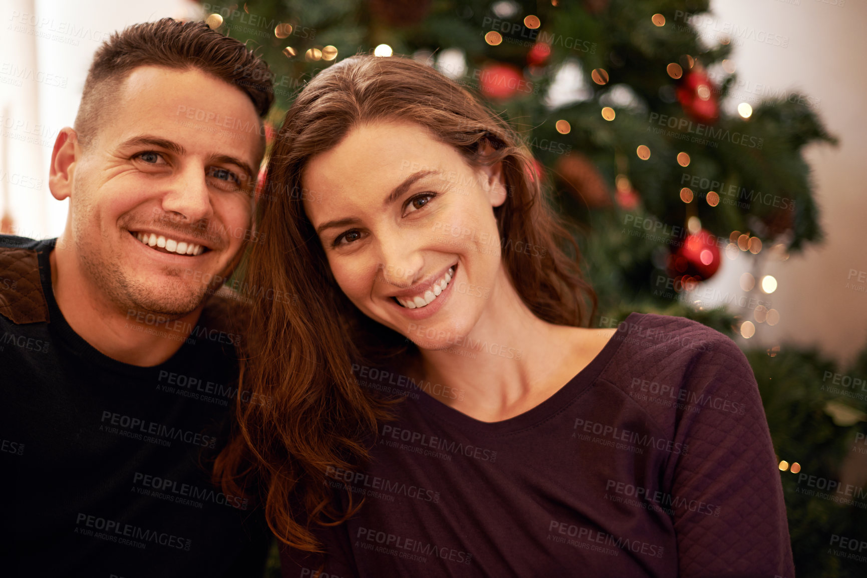 Buy stock photo Couple, portrait and christmas at home with love, support and care together at holiday event. Happy, smile and tree with celebration, trust and marriage in a house with relationship and festive decor