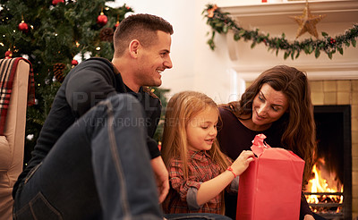 Buy stock photo Family, christmas tree and gift wrapping with kids, parents and box together with giving in living room. Home, happy and present with holiday and celebration at a party with love, care and bonding