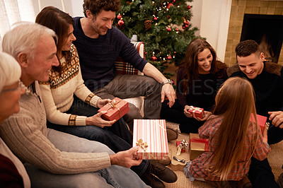 Buy stock photo Family, christmas tree and gift with kids, parents and grandparents together with giving in living room. Home, happy and present with holiday and celebration at a party with love, care and bonding