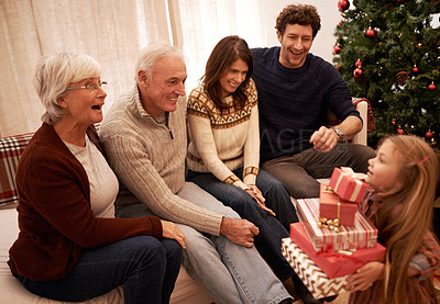 Buy stock photo Christmas, happy family and child with a gift for excited grandparents at home on a winter holiday celebration. Wow, mother and father with a young girl kid giving present boxes to old man and woman