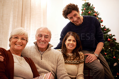 Buy stock photo Christmas, family and visit with a man, woman and senior parents together in the living room of a home. Portrait, happy and bonding with a mother, father and in laws celebrating the festive season