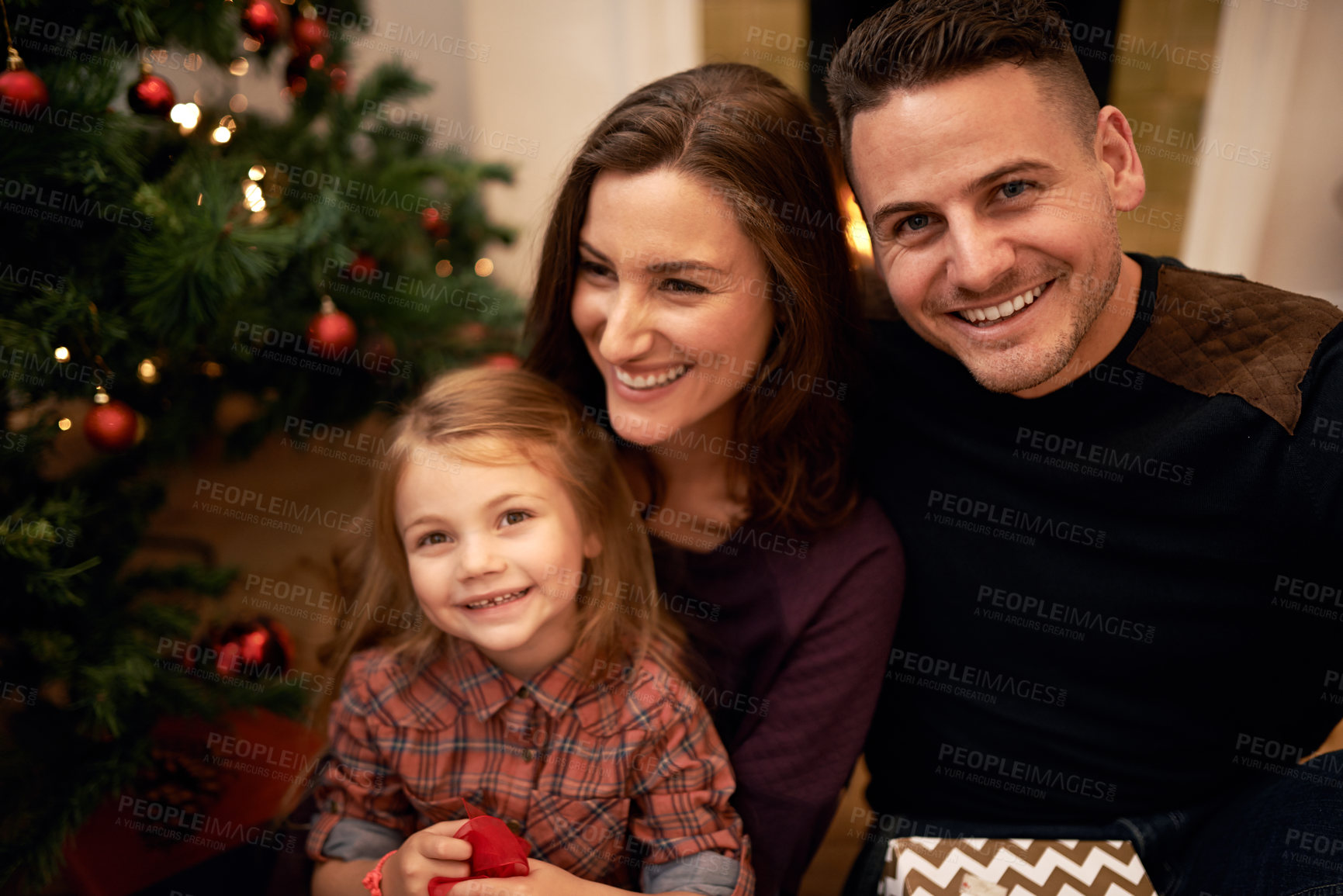 Buy stock photo Happy, portrait and family christmas in home with cheerful smile of mother, dad and daughter. Festive, holiday and happiness in family home with young child for celebration, gifts and love.
