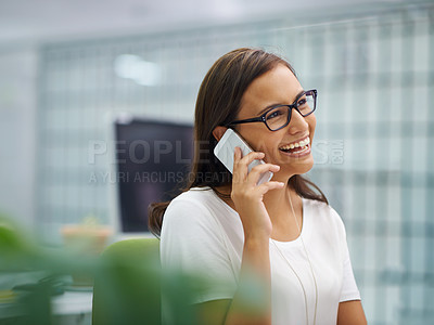 Buy stock photo A young businesswoman on the phone in an office setting