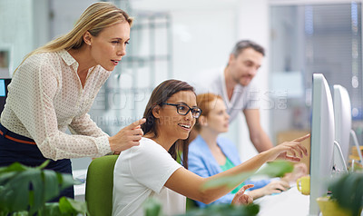 Buy stock photo Shot of an attractive female showing her boss something on her computer screen