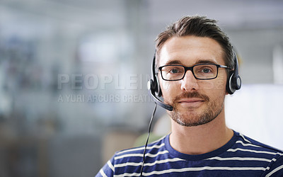 Buy stock photo Portrait of a handsome young businessman wearing a headset in the office