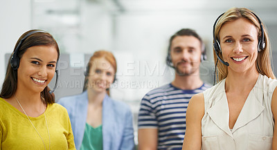Buy stock photo A group of colleagues standing with headsets at the office