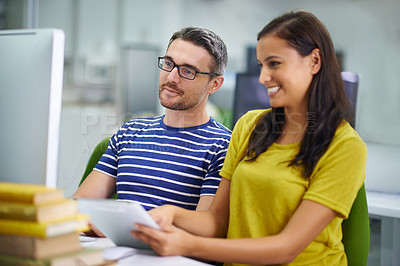 Buy stock photo Two coworkers collaborating using the latest technology