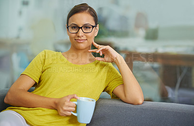 Buy stock photo Shot of an attractive female employee relaxing at work with a hot beverage