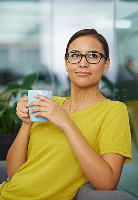 Buy stock photo An attractive female holding a cup of coffee in the office