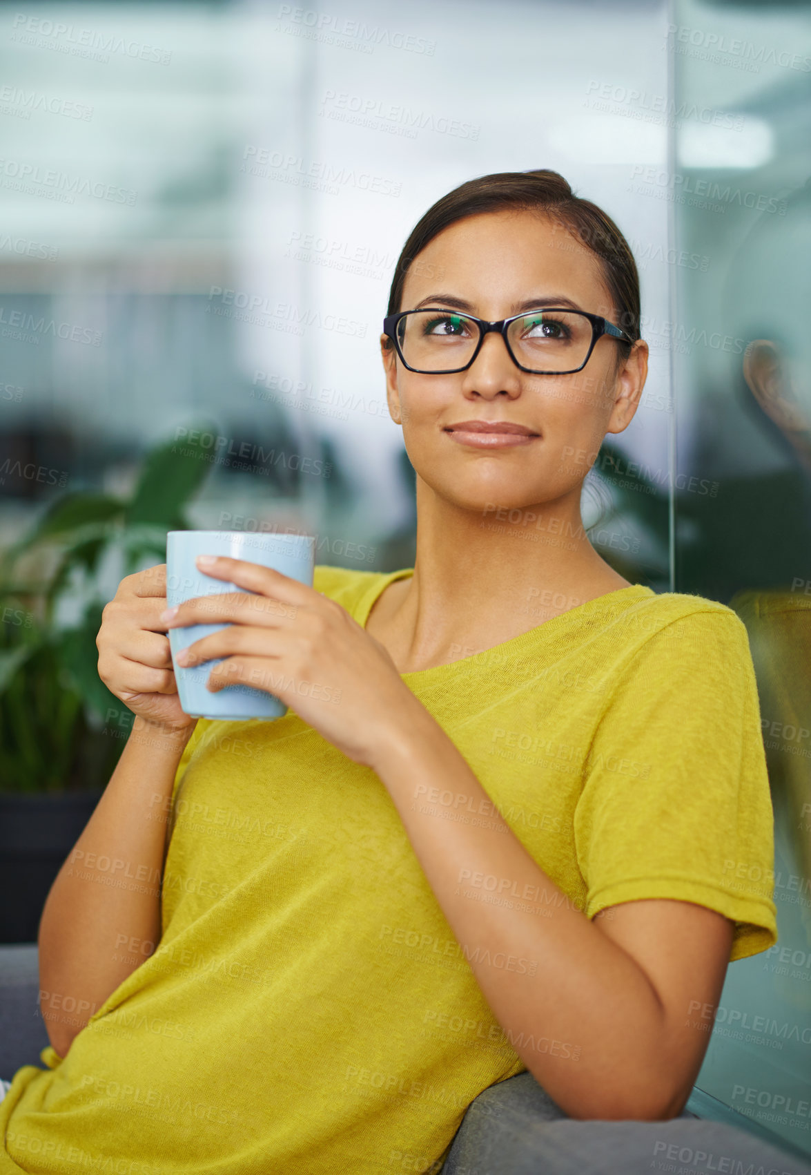 Buy stock photo An attractive female holding a cup of coffee in the office