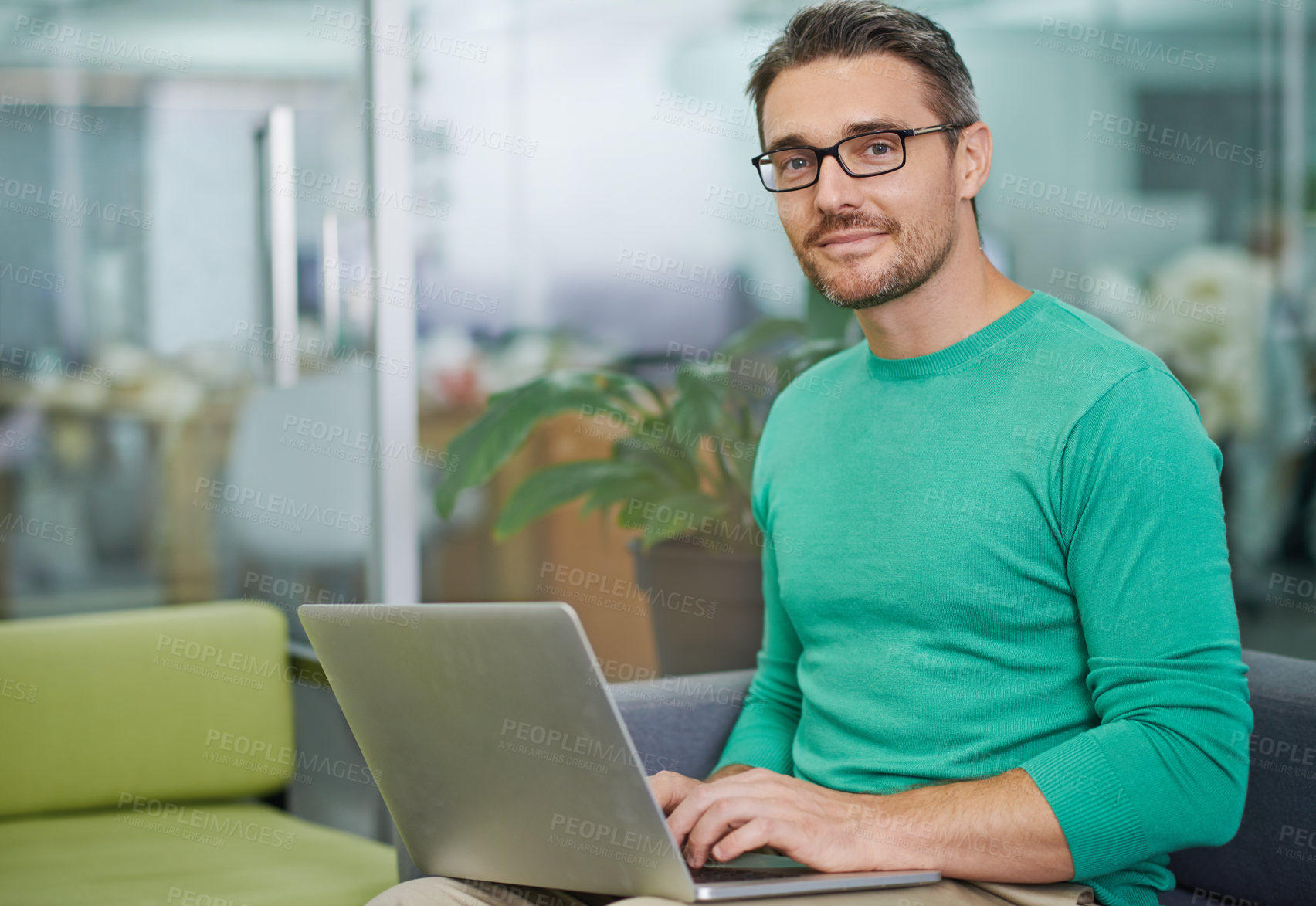Buy stock photo Cropped shot of a handsome man working on his laptop