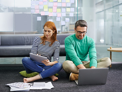 Buy stock photo Woman, man and laptop on floor at startup with tablet, documents and thinking with teamwork in office. Business people, partnership and computer with paperwork for planning at creative media agency