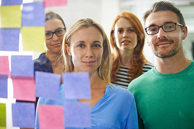 Buy stock photo Portrait of three business colleagues standing in front of a glass wall filled with sticky notes