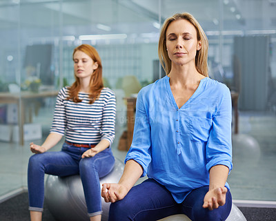 Buy stock photo Two attractive females doing some relaxation exercises indoors
