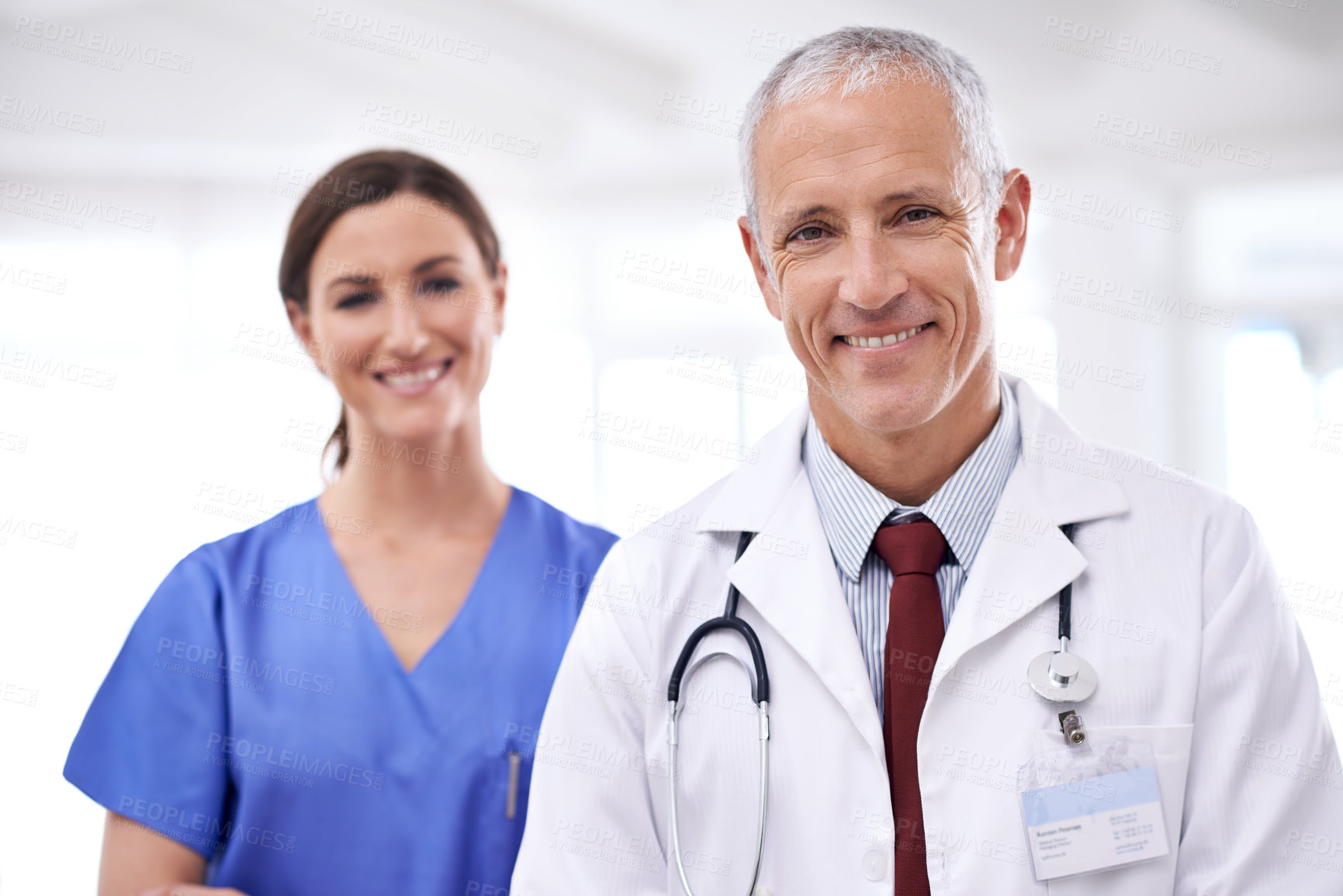 Buy stock photo Doctors, man and woman in portrait at clinic for medical support, wellness and partnership with smile. Mature medic, people and nurse in team, happy or health services at hospital for pride in career