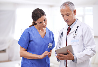 Buy stock photo Doctors, man and woman on tablet, analysis or results for healthcare, wellness or teamwork in hospital. Partnership, doctor and nurse with digital touchscreen for schedule, information or medical app