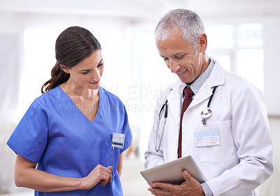Buy stock photo Doctors, man and woman on tablet, team or results for healthcare, wellness or analysis in hospital. Partnership, doctor and nurse with digital touchscreen for health, teamwork or data on medical app