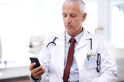 Buy stock photo Healthcare, man and doctor with smartphone in hospital for wellness research, medical app or online consult. Clinic, advice and mature medic by mobile phone for internet, communication or networking