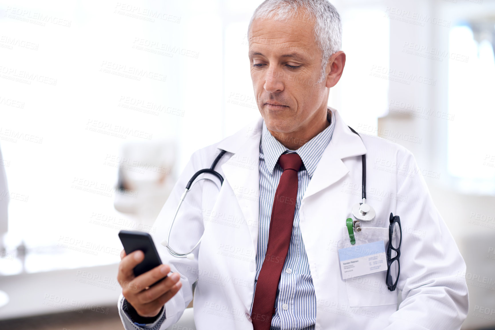 Buy stock photo Healthcare, man and doctor with smartphone in hospital for wellness research, medical app or online consult. Clinic, advice and mature medic by mobile phone for internet, communication or networking