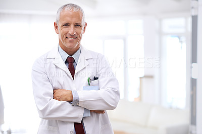 Buy stock photo Portrait of a mature doctor standing with his arms crossed