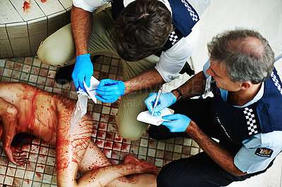 Buy stock photo Shot of investigators working their way through a bloody crime scene