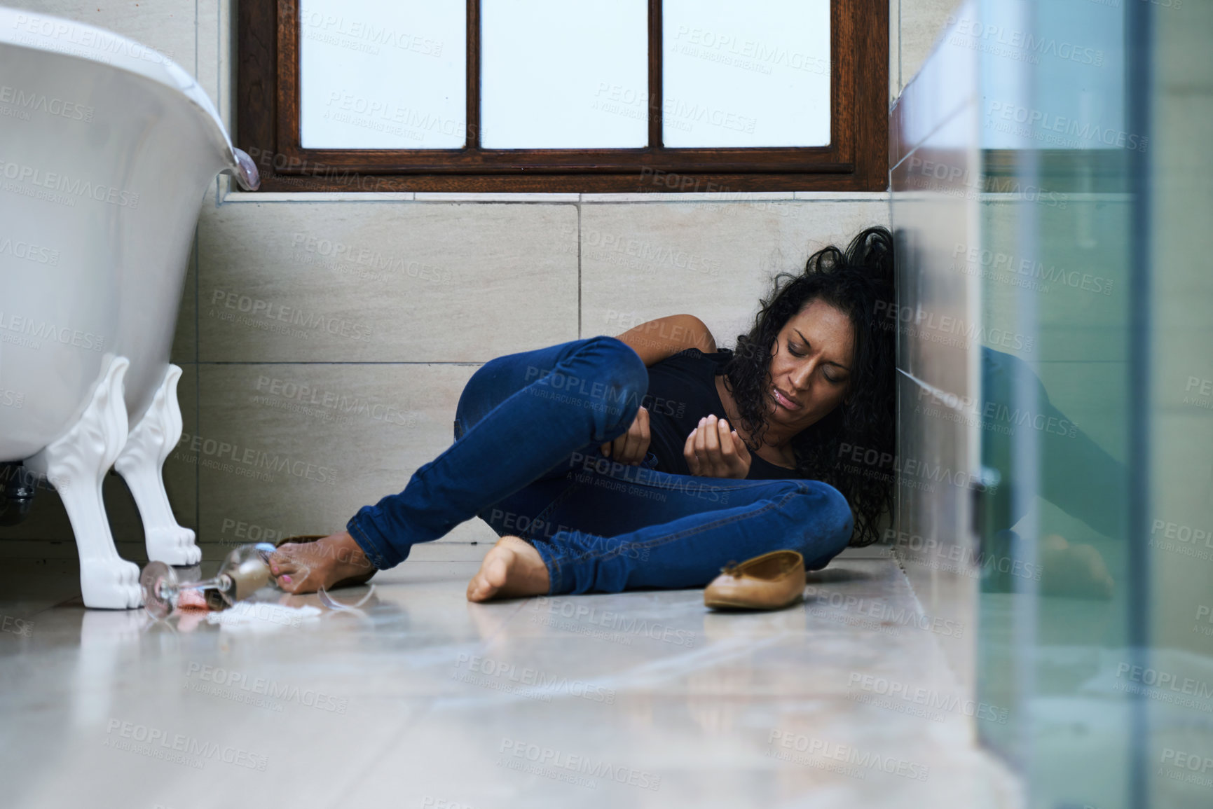 Buy stock photo Shot of a drug addict passed out on the bathroom floor