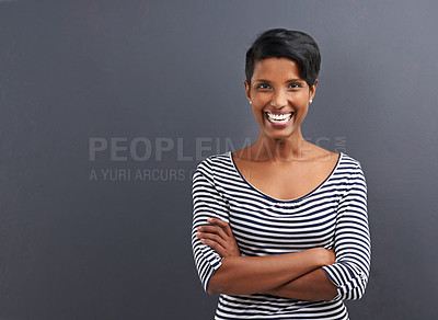 Buy stock photo Portrait of a happy young woman standing on a gray background