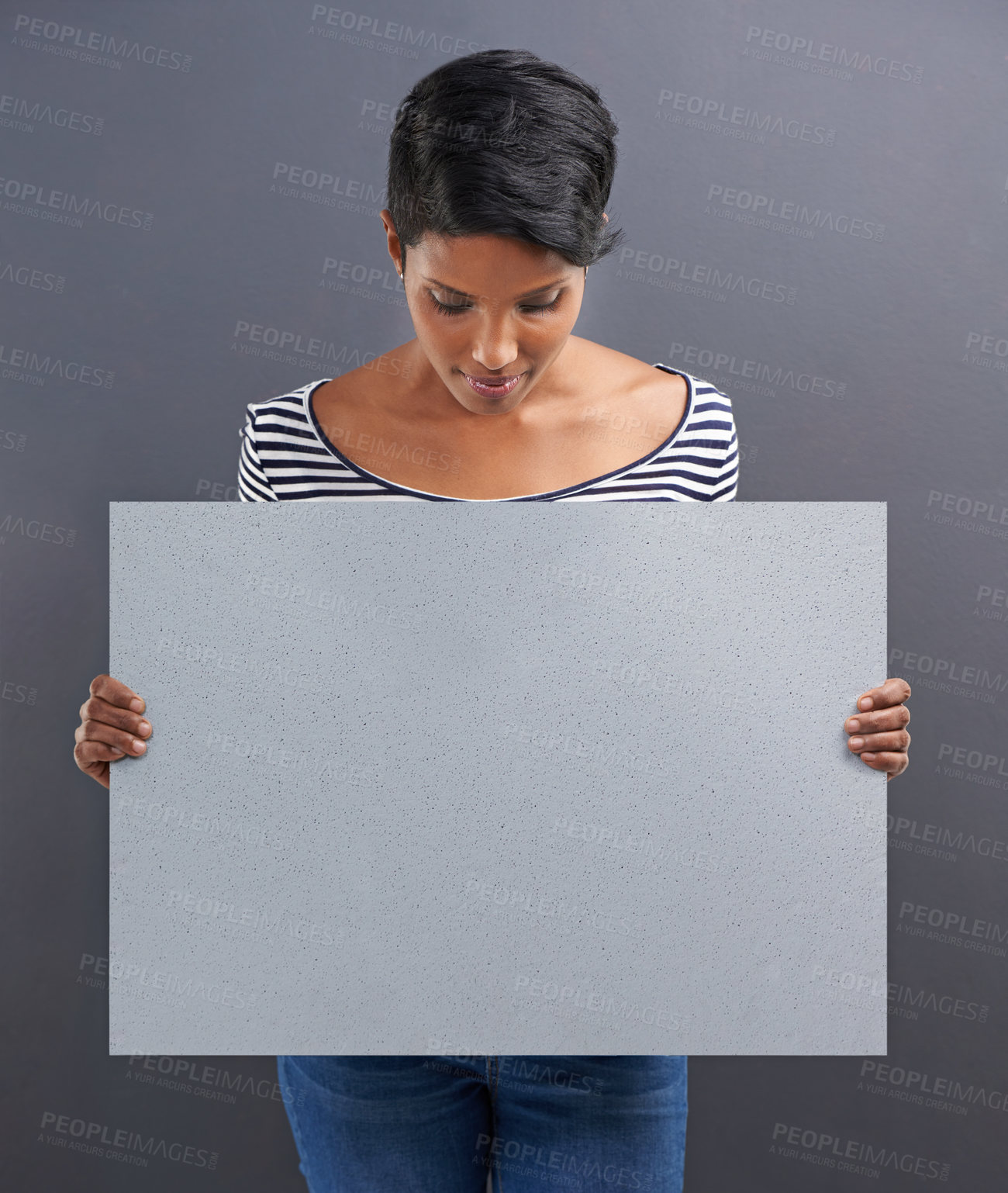 Buy stock photo Woman, presentation and advertising with billboard for marketing on a gray studio background. Young female person or Indian holding poster or sign for notification, alert or message on mockup space