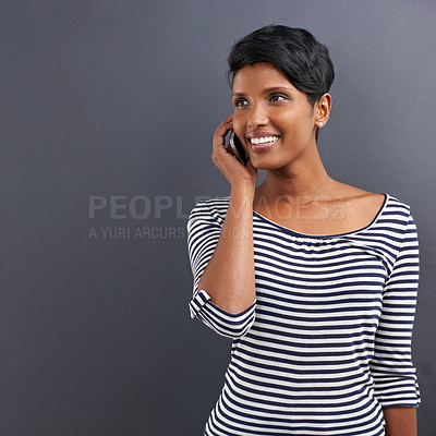 Buy stock photo Happy woman, communication and discussion with phone for call on a gray studio background. Young female person with smile and talking on mobile smartphone for friendly conversation on mockup space