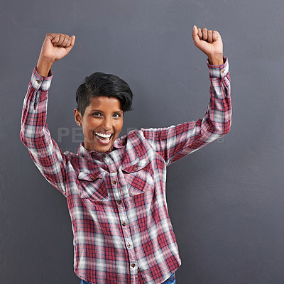 Buy stock photo Excited woman, portrait and dancing with fashion for winning or celebration on a gray studio background. Happy female person, Indian or model with smile for success, style or clothing on mockup space