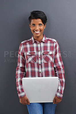 Buy stock photo Happy woman, portrait and fashion with laptop in confidence on a gray studio background. Face of young female person, Indian or freelancer with smile and computer in stylish clothing on mockup space