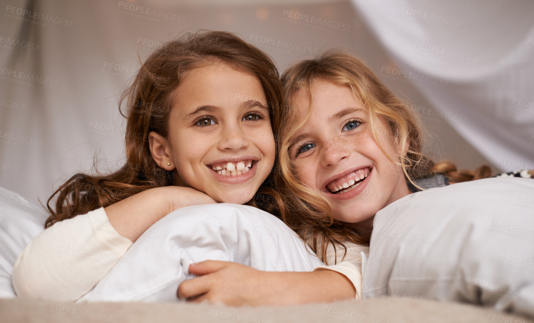 Buy stock photo Happy, home and portrait of children in bedroom for playing, bonding and relax with pillow. Sleepover, friends and young girls on bed with smile, happiness and excited for childhood, fun and laughing