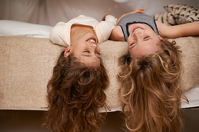 Buy stock photo Happy, sleepover and playful children in bedroom for playing, bonding and relaxing in home. Laugh, friends and young girls upside down on bed for childhood, fun and happiness for youth relationship