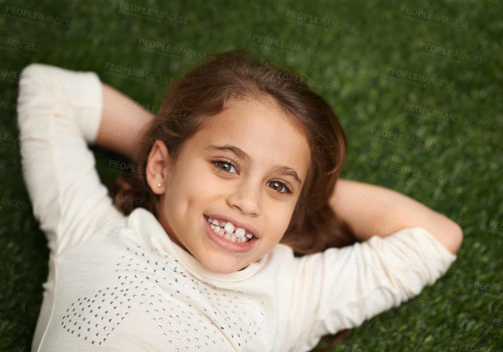 Buy stock photo Portrait, child or happy to relax in childhood, fun or play on grass in garden, park or backyard. Smile, girl or lying in free time, leisure or break in carefree, outdoor activities on mockup space