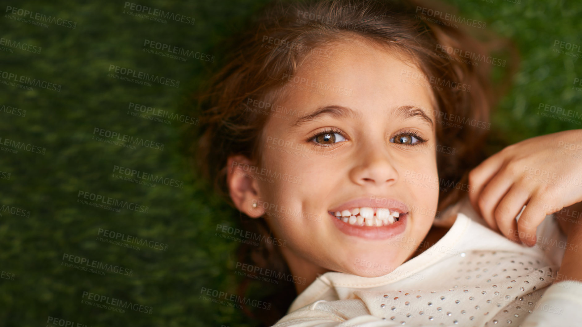 Buy stock photo Portrait, girl or happy to relax in childhood, fun or play on grass in garden, park or backyard. Smile, child or lying in free time, leisure or break in carefree, outdoor activities on mockup space