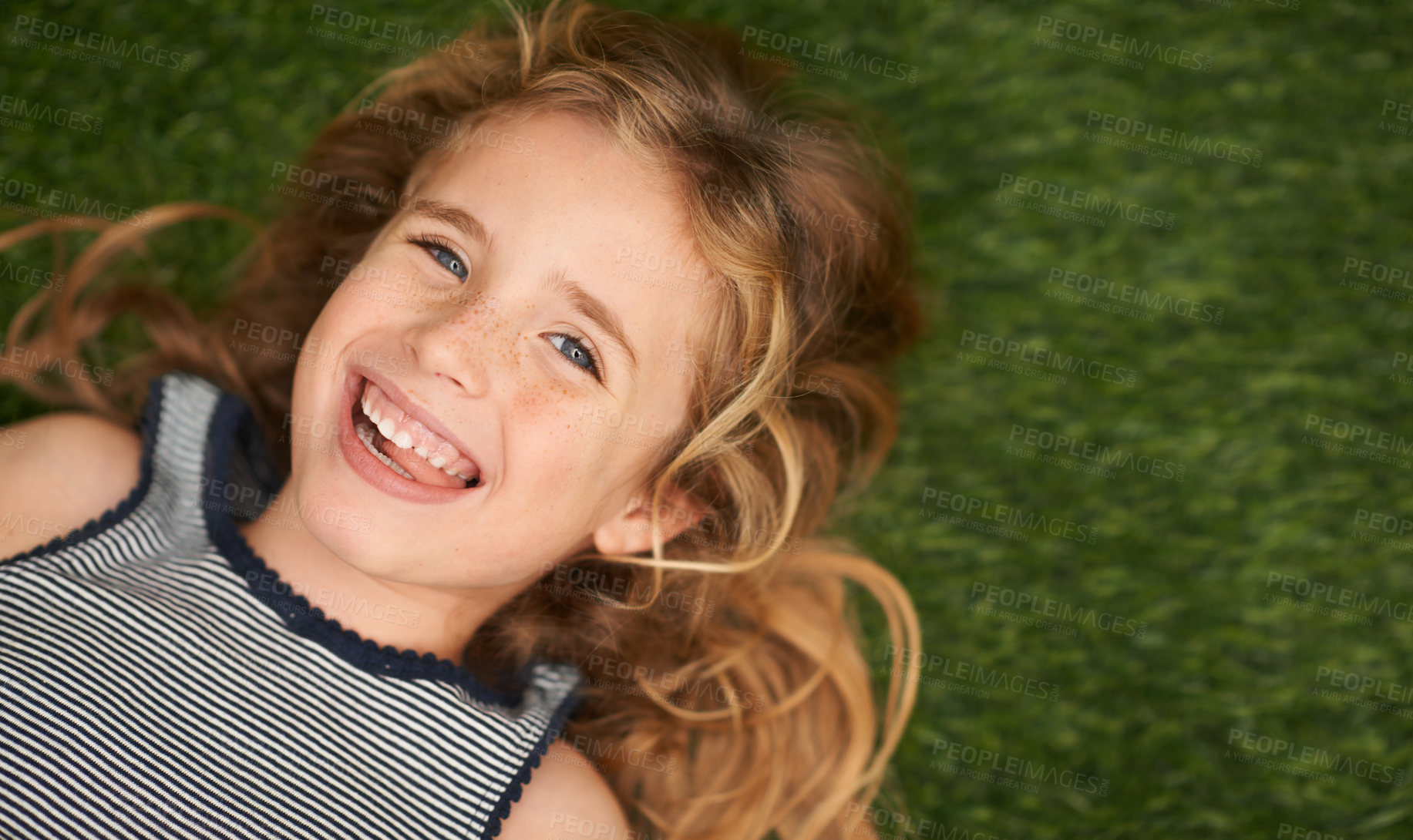 Buy stock photo Top view, child or girl in nature on floor, portrait and smile for joyful kid outdoors. Face, happy and summer season in garden or park for relax, grass and field for play and childhood development 