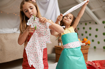 Buy stock photo Shot of two little girls having fun making dresses