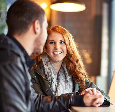 Buy stock photo Couple, hand holding with happy smile woman, romance and affection on date. Valentines day, together with love and bonding, redhead female person in restaurant with boyfriend at table with trust