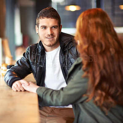 Buy stock photo Couple, hand holding and conversation in restaurant, romance and affection on date. Valentines day, sitting together with love for bonding, female person with boyfriend for trust and compassion 
