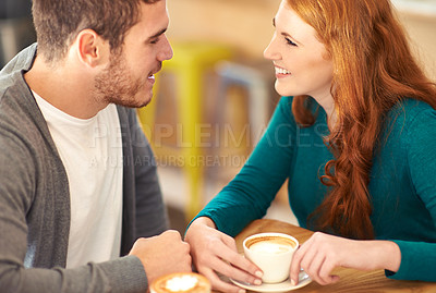Buy stock photo A cropped shot of a young affectionate couple on a coffee date